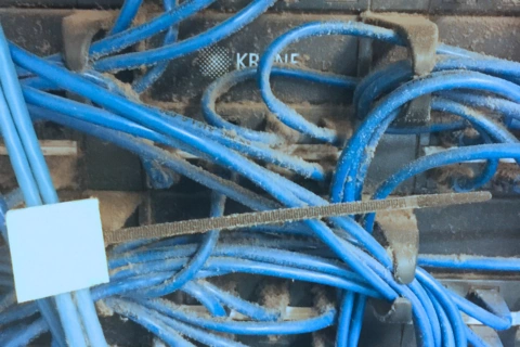 Comms room server rack before cleaning
